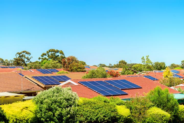 An image showing solar panels on house rooftops