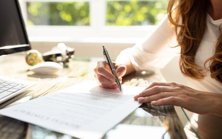 A woman signing a contract