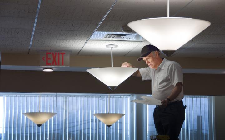 Electrician changing a light bulb