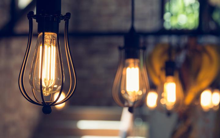 A photo showing decorative lightbulbs hanging in a row from the ceiling. 